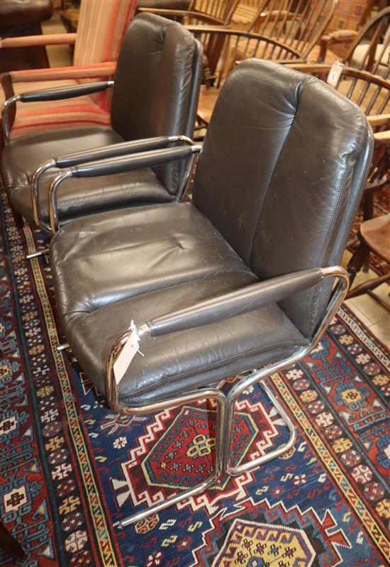 A modern chrome uplighter lamp standard and a pair of leather and chrome chairs